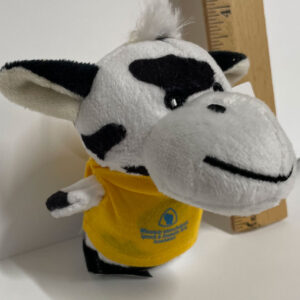Plush cow, about four inches tall, wearing a yellow T-shirt with the WISDAA logo